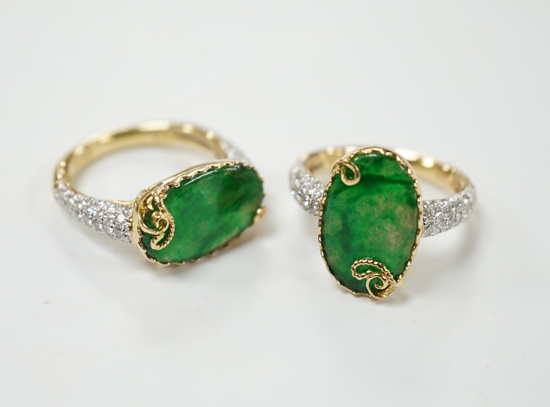 Two similar modern 18k and oval jade set dress rings, with diamond chip set shoulders, sizes K & L, gross weight 9.9 grams. Condition - good